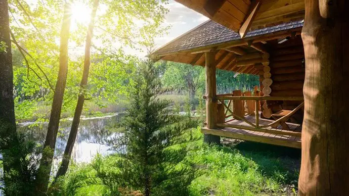 8 Ways to Save Vacation Money Log cabin overlooking a lake