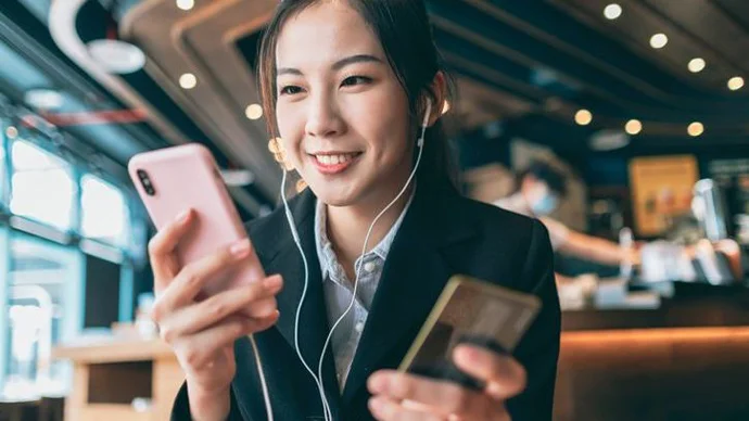 Secure Your Mobile Wallet Young woman making a payment with her phone