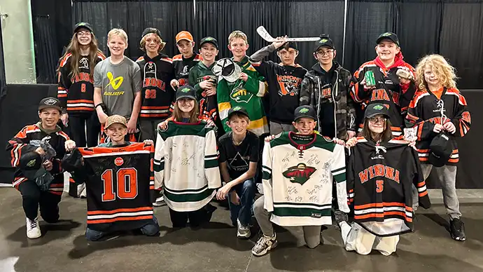 Youth Hockey Teams Raise Over $20,000 for Gillette Children's Winona PeeWee C Team poses with autographed memorabilia