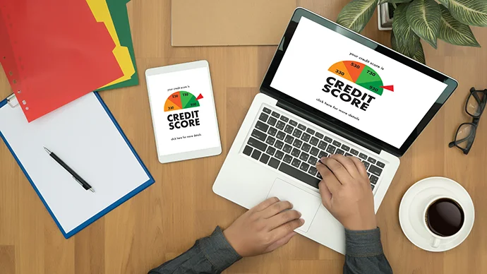 5 Ways Good Credit is Your Safety Net Man looking at his credit score on a laptop