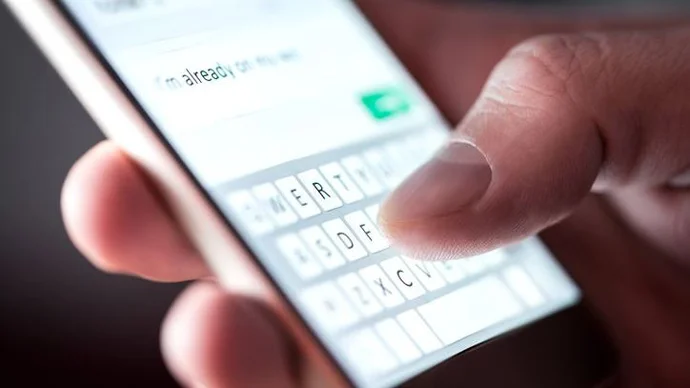 Avoid Phishing Scams Person looking at a scam text