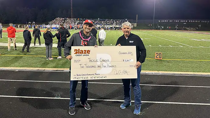 photo of Kent Wipf presenting a check to Tackle Cancer on behalf of MFCA 