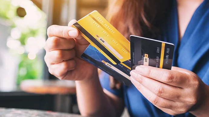 Manage Your Credit Cards Better Woman holding several credit cards in her hand